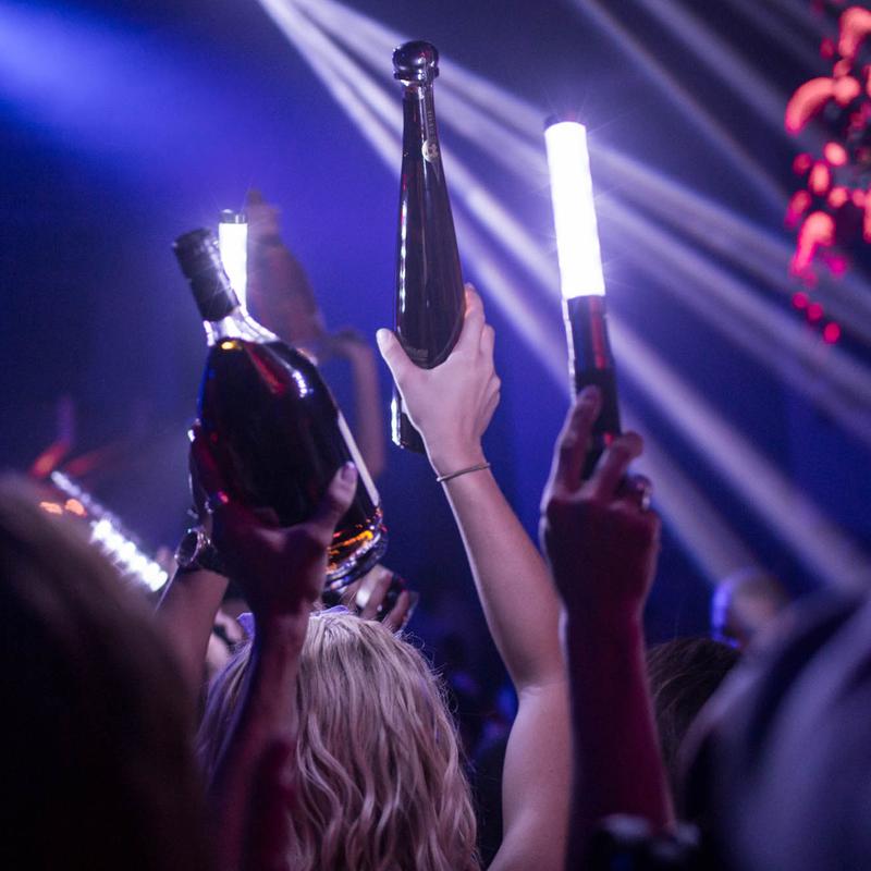 VIP table with bottle service and ambient lamps at Parq