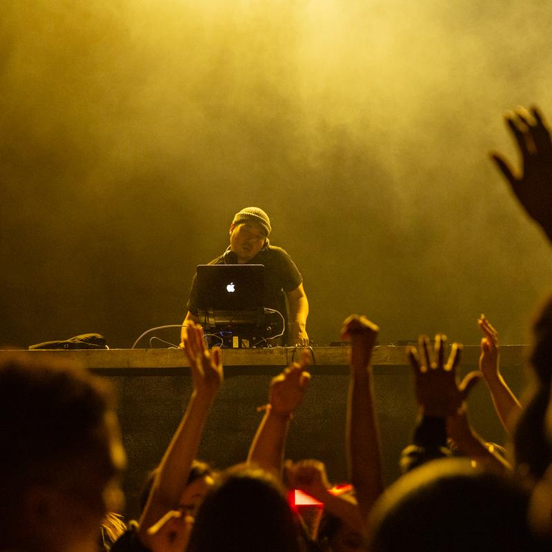 Crowd with hands raised during a DJ set at Parq