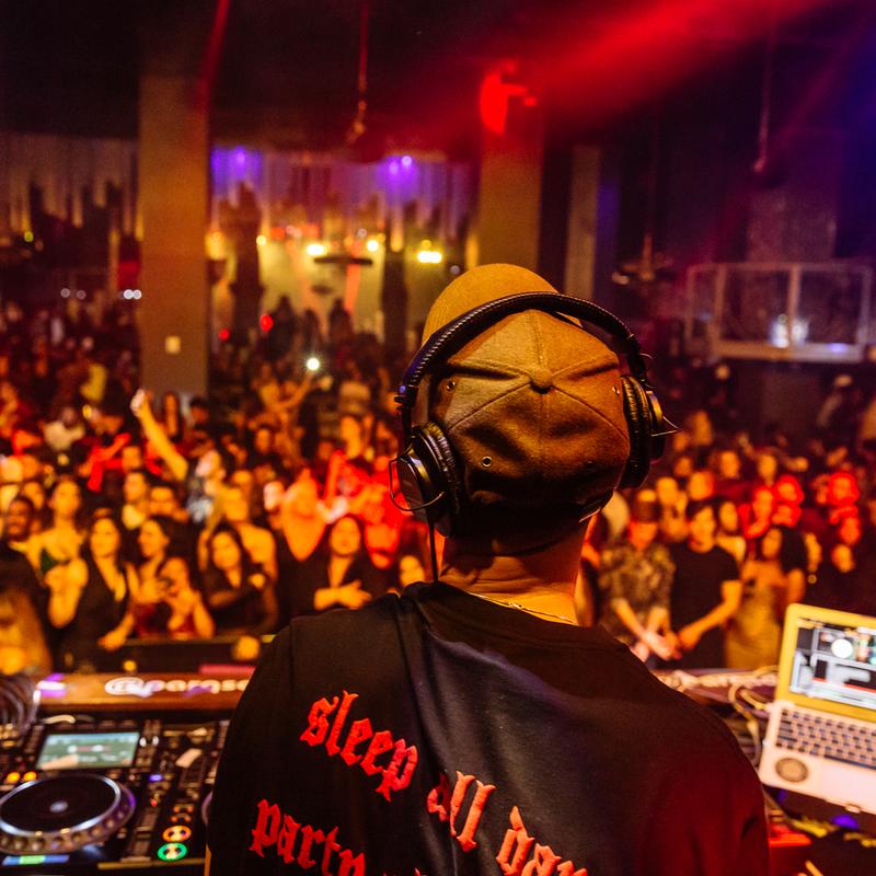 DJ performing to a large crowd at Parq Nightclub
