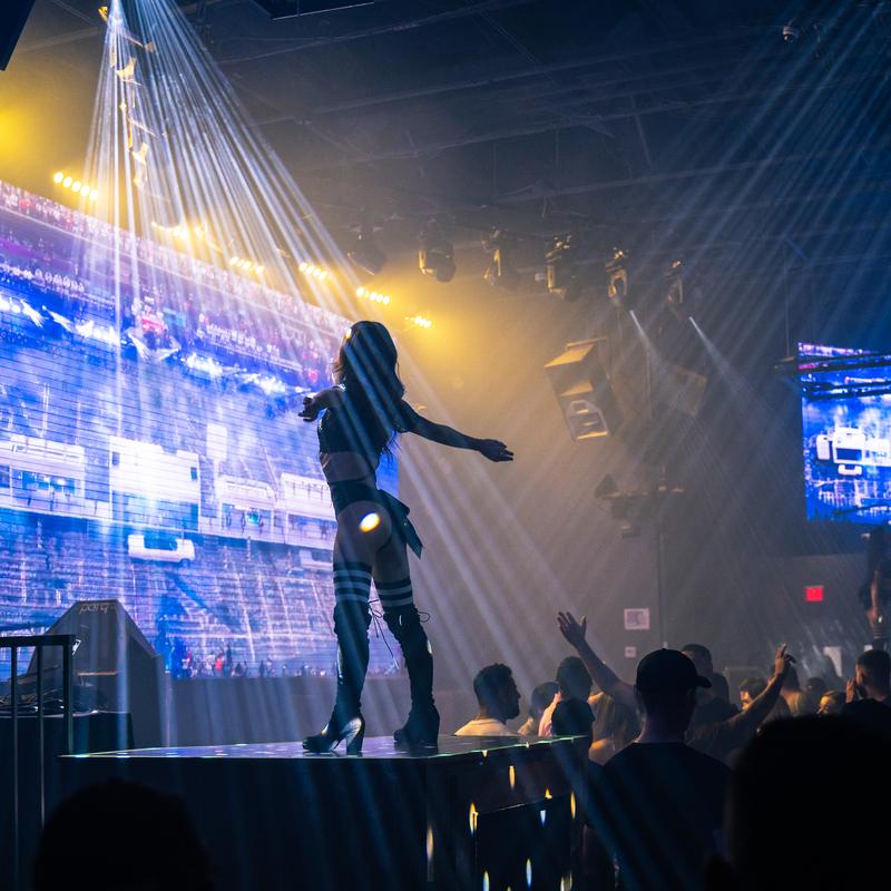Performer on stage under spotlight at Parq Nightclub